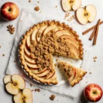 French apple pie with streusel topping on a modern white background