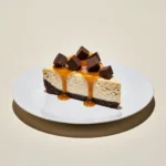 Reese’s caramel cheesecake with chocolate crust and caramel drizzle