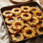 Caramelized roasted pineapple rings on a baking tray