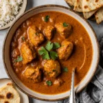 Crockpot Butter Chicken served with rice and naan top-down view